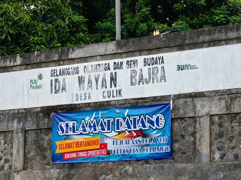 Welcome banner for the PORDES Desa Culik 2026 volleyball championship at Gelanggang Ida Wayan Bajra sports field