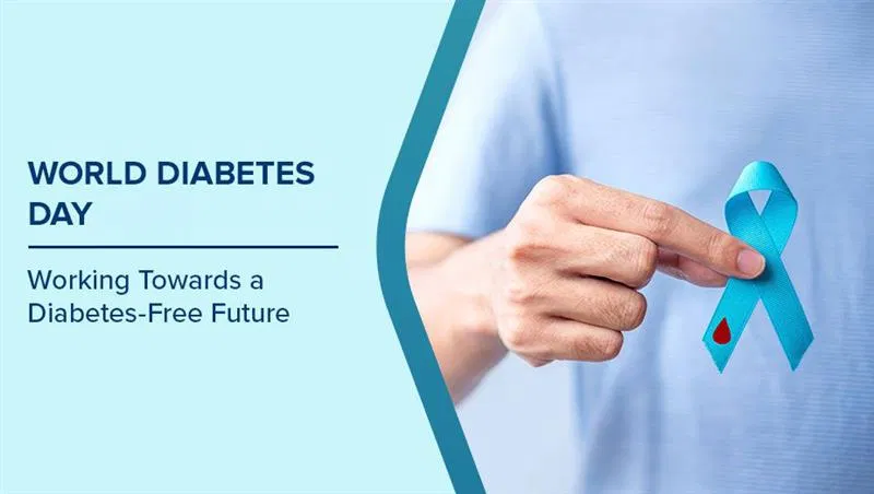 Hand holding a blue ribbon, the symbol of World Diabetes Day, next to the words Working Towards a Diabetes-Free Future